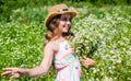 Happy small girl collecting flowers and herbs on sunny day, feel free concept Royalty Free Stock Photo