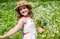 Happy small girl collecting flowers and herbs on sunny day Royalty Free Stock Photo