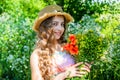 Happy small girl collecting poppy flowers sunny day nature background Royalty Free Stock Photo