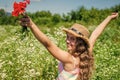 Happy small girl collecting wildflowers on sunny day nature background, Earth day concept Royalty Free Stock Photo