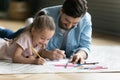 Happy small girl drawing pictures with daddy. Royalty Free Stock Photo