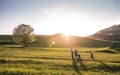 A small girl with her senior grandparents with wheelchair having fun outside in nature. Royalty Free Stock Photo