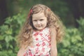 Happy small girl outdoor. Girl having fun in spring park. Blurred background in sunset Royalty Free Stock Photo