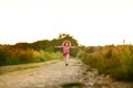 Happy small girl outdoor. Girl having fun in spring park. Blurred background in sunset Royalty Free Stock Photo