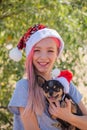 Small girl in santa hat with present have a christmas. little girl in red santa hat. Girl in santa hat Royalty Free Stock Photo