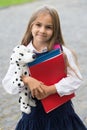 Happy small kid in school uniform hold study books and toy dog friend, friendship Royalty Free Stock Photo