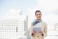 Happy smart brown haired businesswoman using a tablet pc