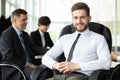 Happy smart business man with team mates discussing in the background Royalty Free Stock Photo