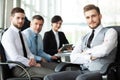 Happy smart business man with team mates discussing in the background Royalty Free Stock Photo