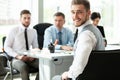 Happy smart business man with team mates discussing in the background Royalty Free Stock Photo