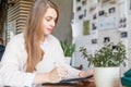 Happy smart businesswoman in casual wear sitting with laptop gadget working in office place