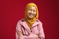 Happy smart cute young confident Asian teenage muslim girl smiling at camera with arms crossed Royalty Free Stock Photo