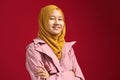 Happy smart cute young confident Asian teenage muslim girl smiling at camera with arms crossed Royalty Free Stock Photo