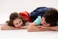 Happy smart primary school students, first grader girl and her brother, teen schoolboy, smiling over white background Royalty Free Stock Photo