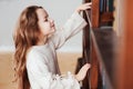 happy smart schoolgirl reading books in library or at home Royalty Free Stock Photo