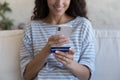 Happy smartphone user woman holding credit card