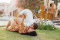 Happy smiing mother with son sitting on grass in park and smiling in camera. Parenting, family, children development Royalty Free Stock Photo