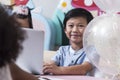 Happy / smile Asean girl and boy using laptop computer together to study online e-learning togeter from living room decorate Royalty Free Stock Photo