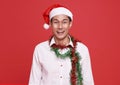 Happy smile asian businessman wearing Santa hat in christmas party  office on isolated over red background.Happy new year concept Royalty Free Stock Photo