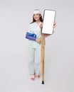 Happy smile asian woman patient put on a cast showing smartphone mockup of blank screen for application insurance and healthcare Royalty Free Stock Photo