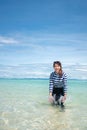 Happy smile Asian woman standing in sea water, Woman wear swimming suit, Travel vacation concept Royalty Free Stock Photo