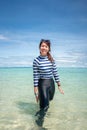 Happy smile Asian woman standing in sea water, Woman wear swimming suit, Travel vacation concept Royalty Free Stock Photo