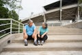 Happy and smile couples elderly asian sitting on stairs for rest after workout, jogging on morning, senior exercise outdoor for