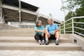 Happy and smile couples elderly asian sitting on stairs for rest after workout, jogging on morning, senior exercise outdoor for