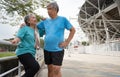 Happy and smile couples elderly asian standing on stairs for rest after workout, jogging on morning, senior exercise outdoor for