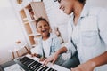 Happy and Smile Girl Play on Piano with Mother. Royalty Free Stock Photo