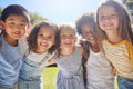 Happy, smile and portrait of kids in a park playing together outdoor in nature with friendship. Happiness, diversity and Royalty Free Stock Photo