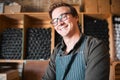 Happy, smile and proud wine, warehouse or manufacturing worker wearing glasses in a cellar with a bottle collection on Royalty Free Stock Photo