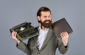 Happy smile. successful businessman use retro typewriter and computer. mature man hold vintage device. first draft Royalty Free Stock Photo