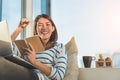 Happy smile young asian woman working with laptop and hold pen with notebook and sitting on sofa at home office, Selective focus Royalty Free Stock Photo