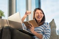Happy smile young asian woman working with laptop and hold pen with notebook and sitting on sofa at home office, Selective focus Royalty Free Stock Photo