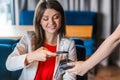 Happy smiley beautiful brunette young woman sitting with mobile smart phone and paying by pay pass pos. contactless, nfc