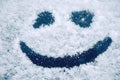 Happy smiley emoticon face in snow Royalty Free Stock Photo