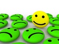 Happy smiley face among sad smileys Royalty Free Stock Photo