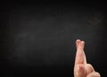 Happy smiley fingers looking at empty black chalboard Royalty Free Stock Photo