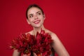 Happy smilig woman with flowers. Beauty brunette girl with tulips bouquet. Beautiful sensual woman hold tulip, studio Royalty Free Stock Photo