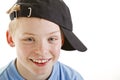 Happy smiling 12 year old boy with a cap isolated Royalty Free Stock Photo