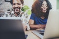 Happy smiling african american couple working together at home.Young black man and his girlfriend using laptop at home Royalty Free Stock Photo