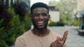 Happy smiling African American man smile applauding looking at camera outdoors in city park cheerful successful Royalty Free Stock Photo