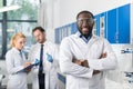 Happy Smiling African American Scientist Stand In Front Of Colleagues In Laboratory Making Notes Of Experiment Or