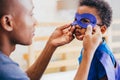 Happy smiling African American son being supported and helped by supportive father Royalty Free Stock Photo