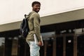 Happy smiling african american student with backpack and laptop on university background Royalty Free Stock Photo