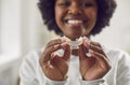 Happy, smiling African American woman holding a plastic tray for teeth whitening Royalty Free Stock Photo