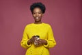 Happy smiling african american woman holding takeaway paper hot coffee tea cup, having break pause Royalty Free Stock Photo