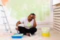 Happy smiling african american woman painting interior wall of new house. Redecoration, renovation, apartment repair and Royalty Free Stock Photo