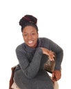 Lovely black female sitting in an old chair in close up Royalty Free Stock Photo